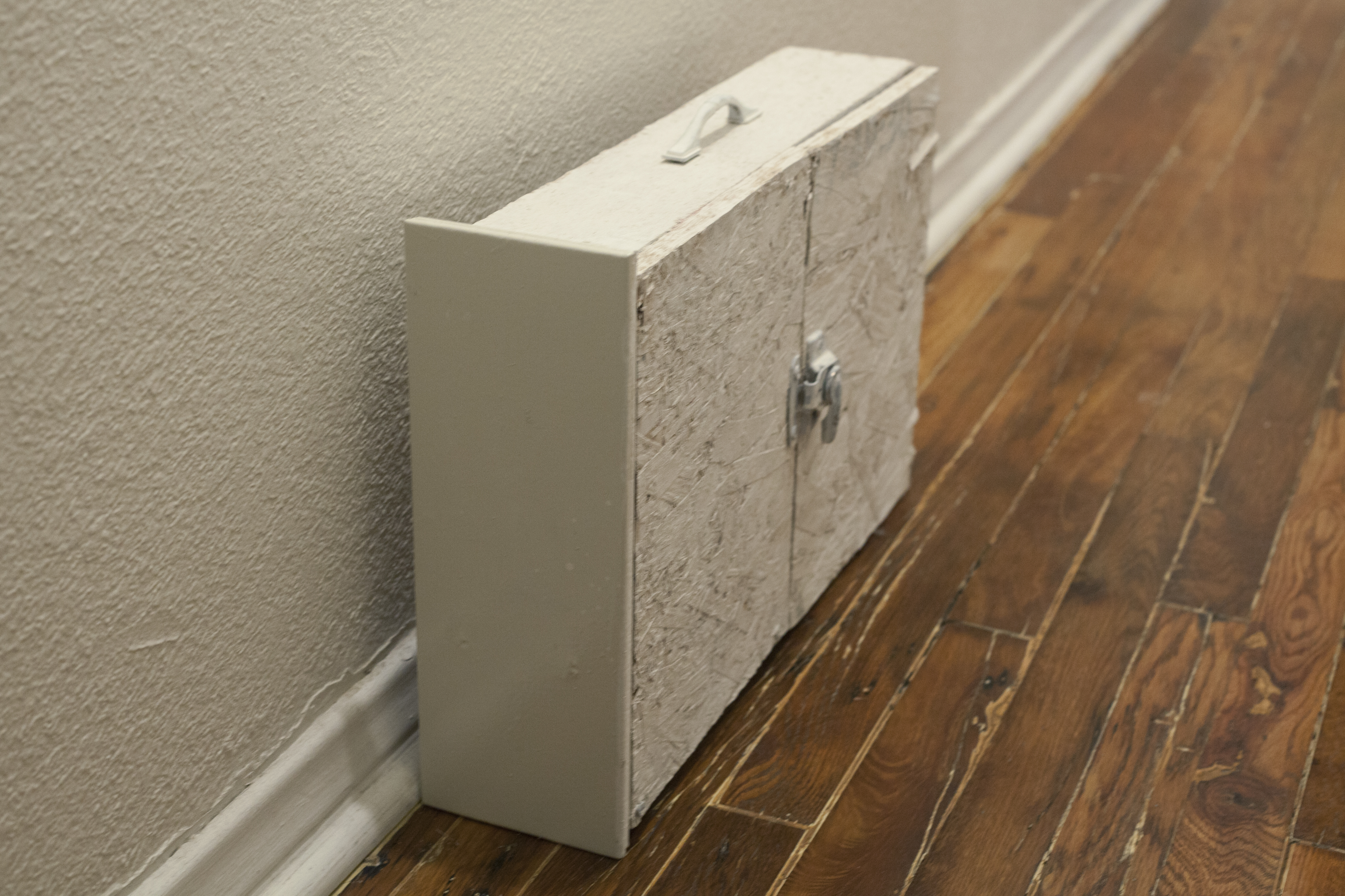 A breifcase made out of a drawer on the floor